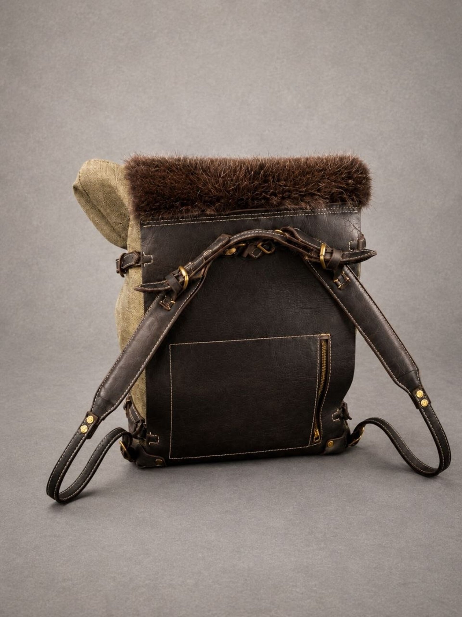 Handcrafted beaver fur backpack with waxed canvas body and full-grain leather details.